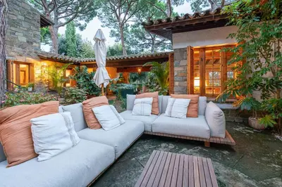a living room with two couches and an umbrella at Villa Can Duarry - Barcelona Country House 1 in Premia de Dalt