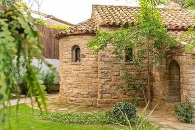 a brick building with a window in a yard at Villa Can Duarry - Barcelona Country House 1 in Premia de Dalt