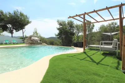a swimming pool with a bench and a pergola at Villa Paradise , playa privada a 10 minutos de Sitges in Sant Pere de Ribes