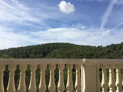a white fence with a mountain in the background at Villa Paradise , playa privada a 10 minutos de Sitges in Sant Pere de Ribes
