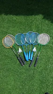 four tennis rackets are lined up on the grass at Villa Paradise , playa privada a 10 minutos de Sitges in Sant Pere de Ribes