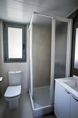 a bathroom with a shower and a toilet and a sink at Apartaments Can Negret in Sitges
