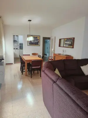 a living room with a couch and a table at Apartamento duplex vacacional in Arenys de Mar