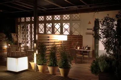 a restaurant with potted plants on a wooden floor at B&B Boutique Ca La Maria in Barcelona