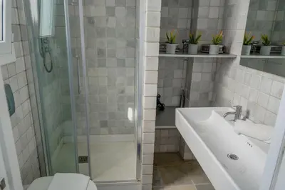 a bathroom with a shower and a sink and a toilet at Angel Views Penthouse by Hello Homes Sitges in Sitges