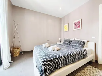 a bedroom with a bed with two towels on it at Bo&Co Apartments in Sitges