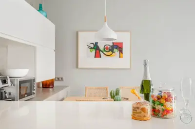 a kitchen with a white counter top with a jar of candy at Bo&Co Apartments in Sitges