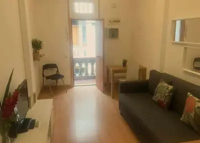 a living room with a couch and a table at Pretty Apartament in Barcelona