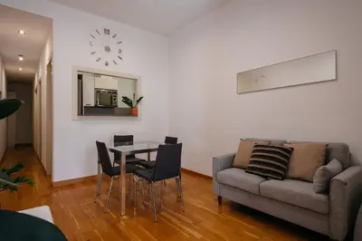 a living room with a table and a couch at Cute Apartment in Barcelona