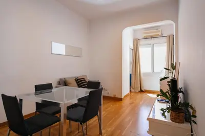 a living room with a table and chairs and a couch at Cute Apartment in Barcelona