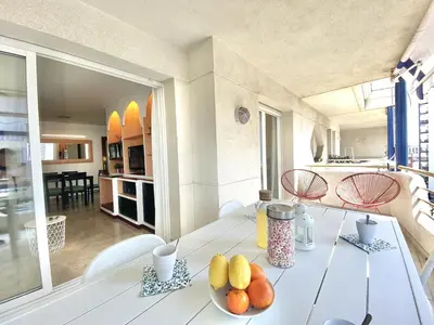 a living room with a white table with fruit on it at Duplex oasis in Sitges