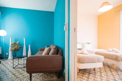 a living room with a couch and a bed at Be barcelona arco del triunfo sunny colors 2 in Barcelona