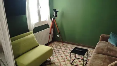 a room with a green wall with a camera and a chair at Be barcelona arco del triunfo sunny colors 2 in Barcelona