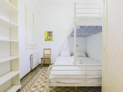 a bedroom with two bunk beds and a ladder at Be barcelona arco del triunfo sunny colors in Barcelona