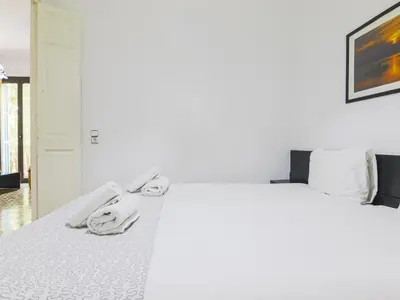 a white bed with white sheets and towels on it at Be barcelona arco del triunfo sunny colors in Barcelona