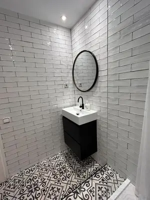 a white tiled bathroom with a sink and a mirror at Be barcelona arco del triunfo sunny colors in Barcelona