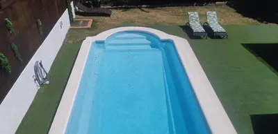 an overhead view of a swimming pool with two benches at Edard's Private Villa in Castelldefels