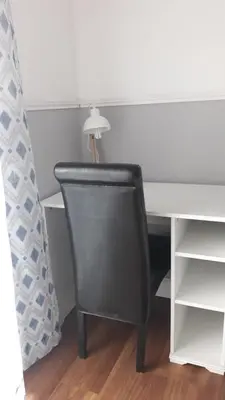 a black chair sitting next to a white desk at Edard's Private Villa in Castelldefels