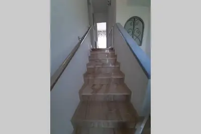 a stairway with a blue railing and a stair case at Edard's Private Villa in Castelldefels