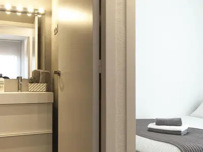 a bathroom with a sink and a mirror at Lets holidays apartment in Sant Martí in Barcelona