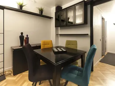 a dining room with a black table and chairs at Lets holidays apartment in Sant Martí in Barcelona
