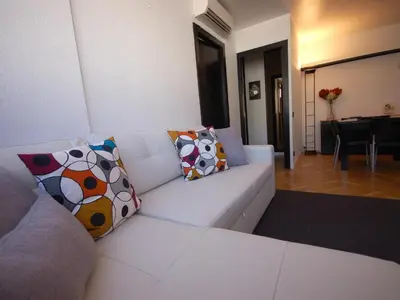 a white couch with pillows in a living room at Lets holidays apartment in Sant Martí in Barcelona