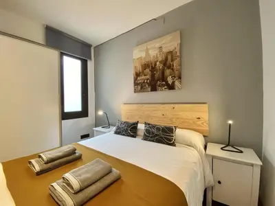 a bedroom with a large white bed with two pillows at Sagrada familia apartment in Barcelona