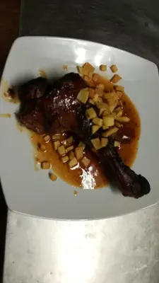 a plate of food with meat and nuts on it at Hostal Restaurante La Diligencia in Cunit
