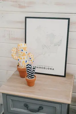 two potted plants sitting on a table with a picture at BBarcelona Fira Superior Flats in Barcelona