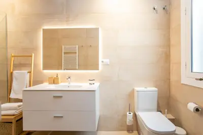 a bathroom with a white sink and a toilet at Canela Homes BARCELONA MARINA in Barcelona