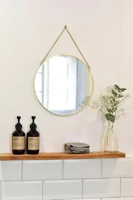 a mirror on a shelf with two bottles of soap at CASA FILOMENA in Barcelona