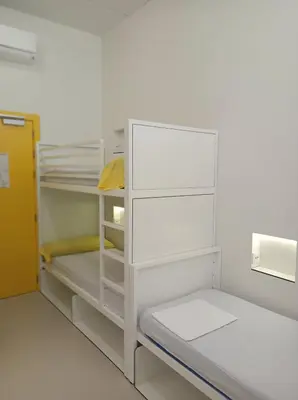 a white room with a bunk bed in it at Alberg Barcelona Xanascat in Barcelona