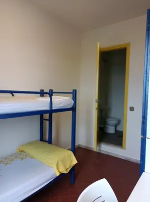 a room with two bunk beds and a toilet at Alberg Barcelona Xanascat in Barcelona