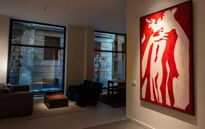 a living room with a large painting on the wall at Hotel California in Barcelona