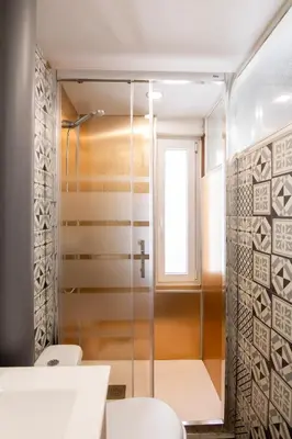 a glass shower in a bathroom with two toilets at Pedrera - Gràcia in Barcelona