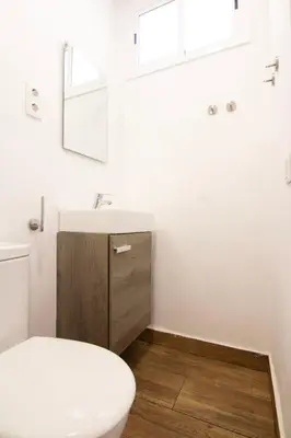 a bathroom with a white sink and a toilet at Pedrera - Gràcia in Barcelona