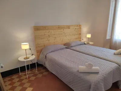 a bedroom with two beds and two lamps on tables at Hostal Dragonflybcn in Barcelona