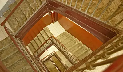 an overhead view of a spiral staircase with wood at Hostal Dragonflybcn in Barcelona