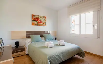 a bathroom with a mirror and a wooden shelf at BONITO APARTAMENTO in Sitges