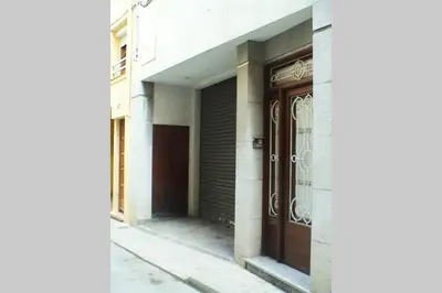 a building with a brown door and a street at Calella Playa in Calella