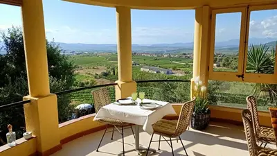 a table and chairs on a balcony with a view at Cal Mestre Casa Rural in Avinyonet
