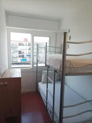 a bedroom with two bunk beds and a window at Can Mabi, 30' Bcn next beach in Vilassar de Mar