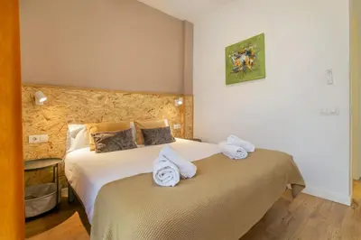 a bedroom with a bed with towels on it at Chic and Modern Apartments in Gracia in Barcelona