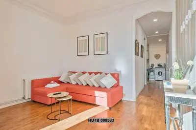 a living room with a red couch and a table at Alcam Berlin-Numancia in Barcelona