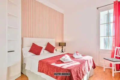 a bedroom with a white bed with red pillows at Alcam Berlin-Numancia in Barcelona