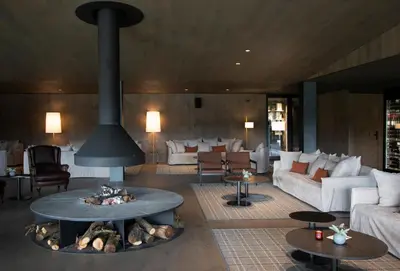a living room with a fire pit in the middle at Les Cabanes de l'Oller del Mas in Manresa