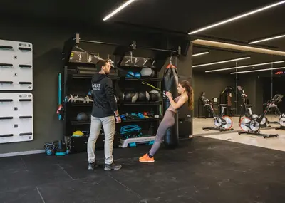 a man and a woman standing in a gym at Les Cabanes de l'Oller del Mas in Manresa