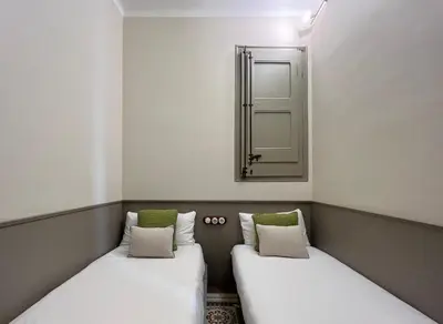 two beds in a small room with a mirror at Stay U-nique Apartments Borbó II in Barcelona