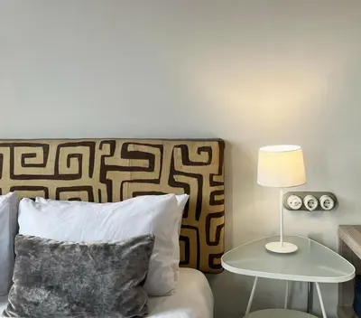 a bedroom with a bed and a table with a lamp at Stay U-nique Apartments Borbó II in Barcelona