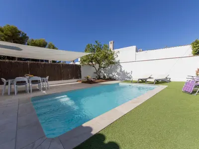 a swimming pool in a yard with a table and chairs at Holiday Home Aeris by Interhome in Cunit